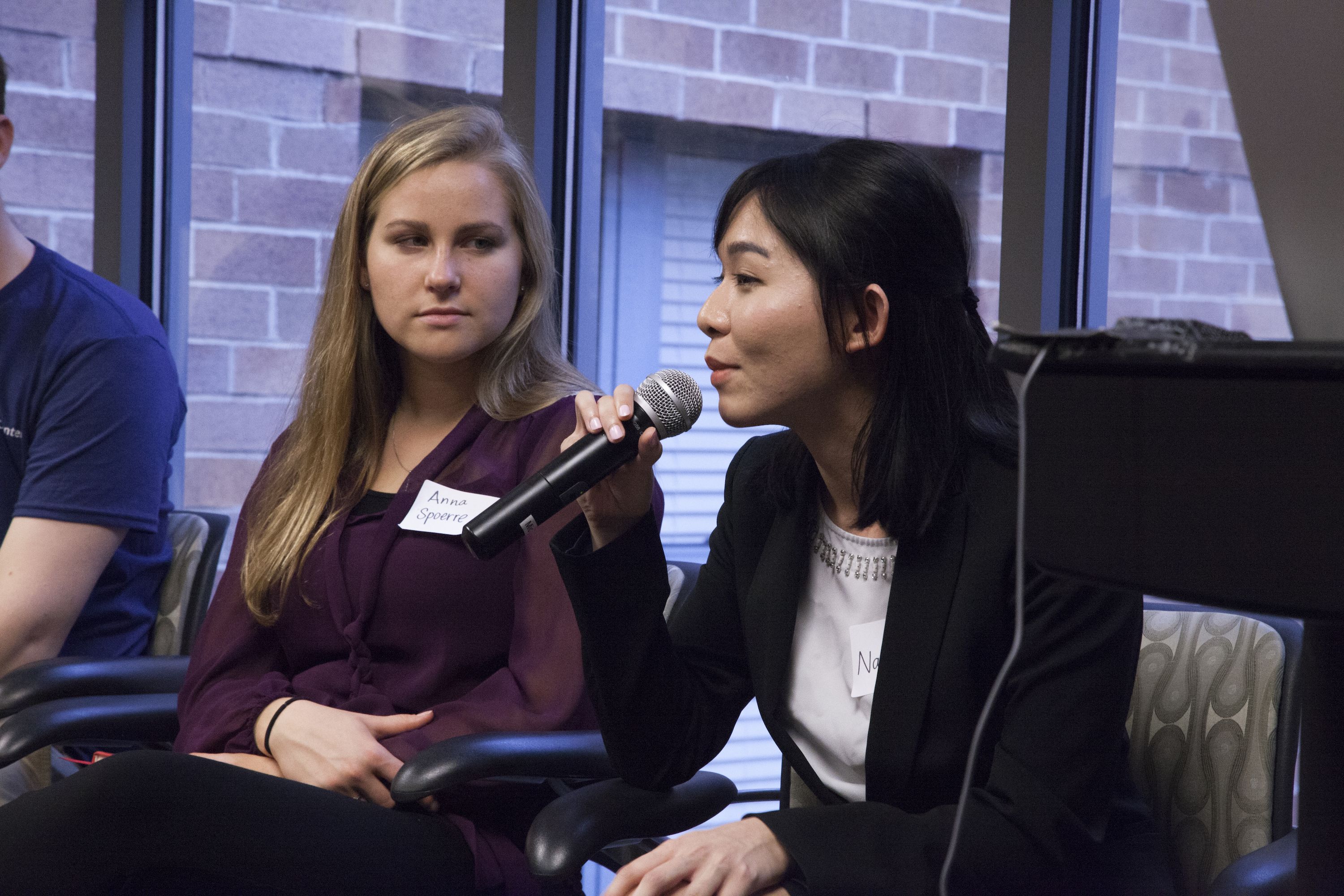 Natalie Au answers questions about her reporting on innovative solutions for gender equality in India. SIU Carbondale fellow Anna Spoerre listens, after presenting her project on Peru's public education system. Image by Jin Ding. Washington, D.C., 2016.