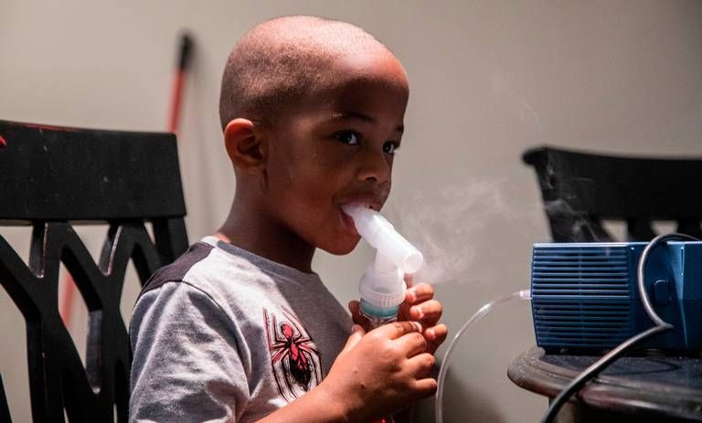 Four-year-old Jeremiah Galbreath receives a nebulizer treatment for asthma at his home in Bayboro Thursday, Aug. 20, 2020. Eastern North Carolina has more people making trips to hospital emergency departments for asthma treatments than in any other part of the state, researchers at East Carolina University reported. Image by Travis Long / The News & Observer. United States, 2020.
