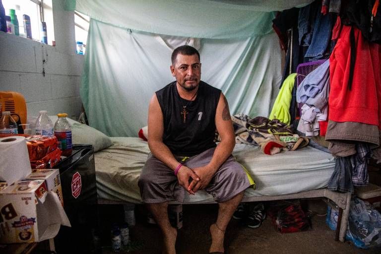 Jose, a tractor operator, sits in his living quarters at a Johnston County farmworker camp Thursday August 27, 2020. The camp does not have air conditioning which is considered a luxury by many farmworkers in North Carolina. Image by Travis Long. United States, 2020.