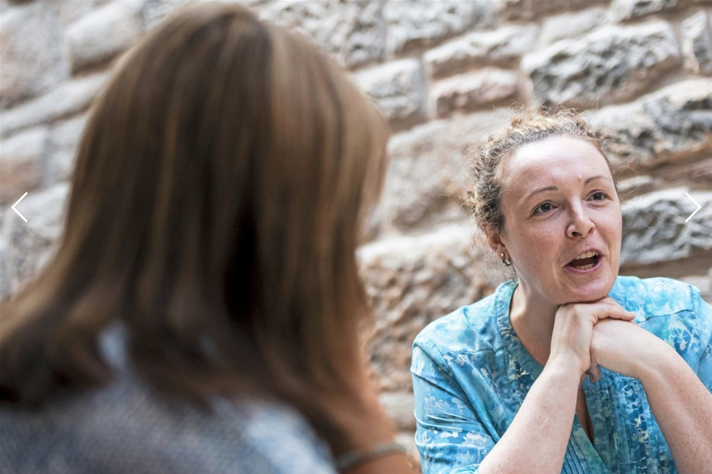 Mary Stewart, NHS health specialist, left, listens to Joanne Egan, of Carntyne, a suburb of Glasgow, Scotland, right, as she speaks about her experiences and why she attends Cafe Stork, Tuesday, Oct. 21, 2019, at Parkhead Congregational Church. Image by Michael M. Santiago. United Kingdom, 2019.