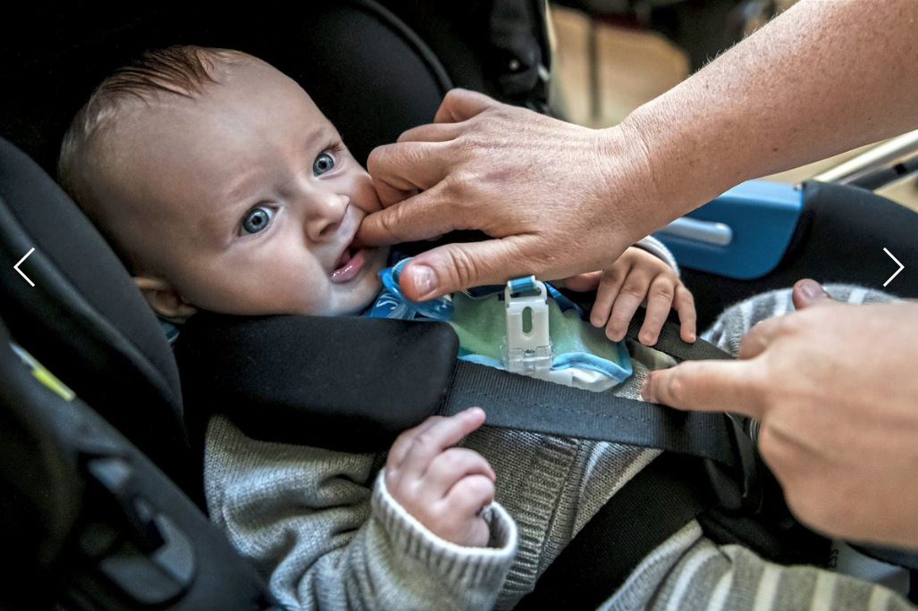 Joanne Egan places ointment for teething on the gums of her son, Conor, while attending Cafe Stork, Tuesday, Oct. 21, 2019, at Parkhead Congregational Church in Glasgow, Scotland. Image by Michael M. Santiago. United Kingdom, 2019.