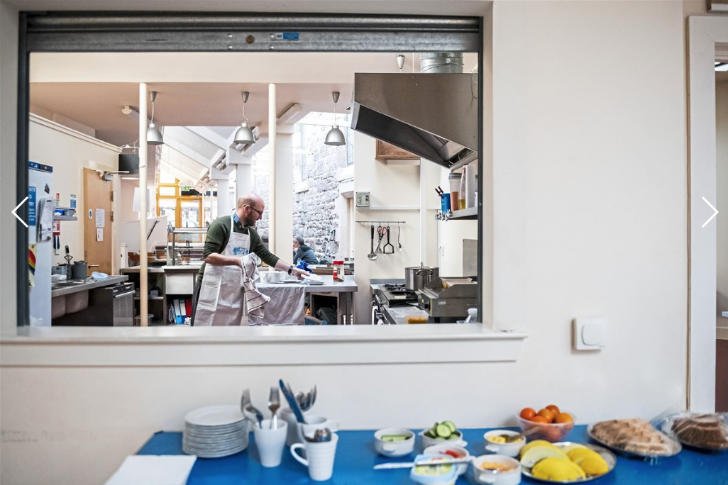 James Leitch, health improvement assistant practitioner at NHS, cleans up after preparing meals for attendees at Cafe Stork, Tuesday, Oct. 21, 2019. Image by Michael M. Santiago. United Kingdom, 2019.