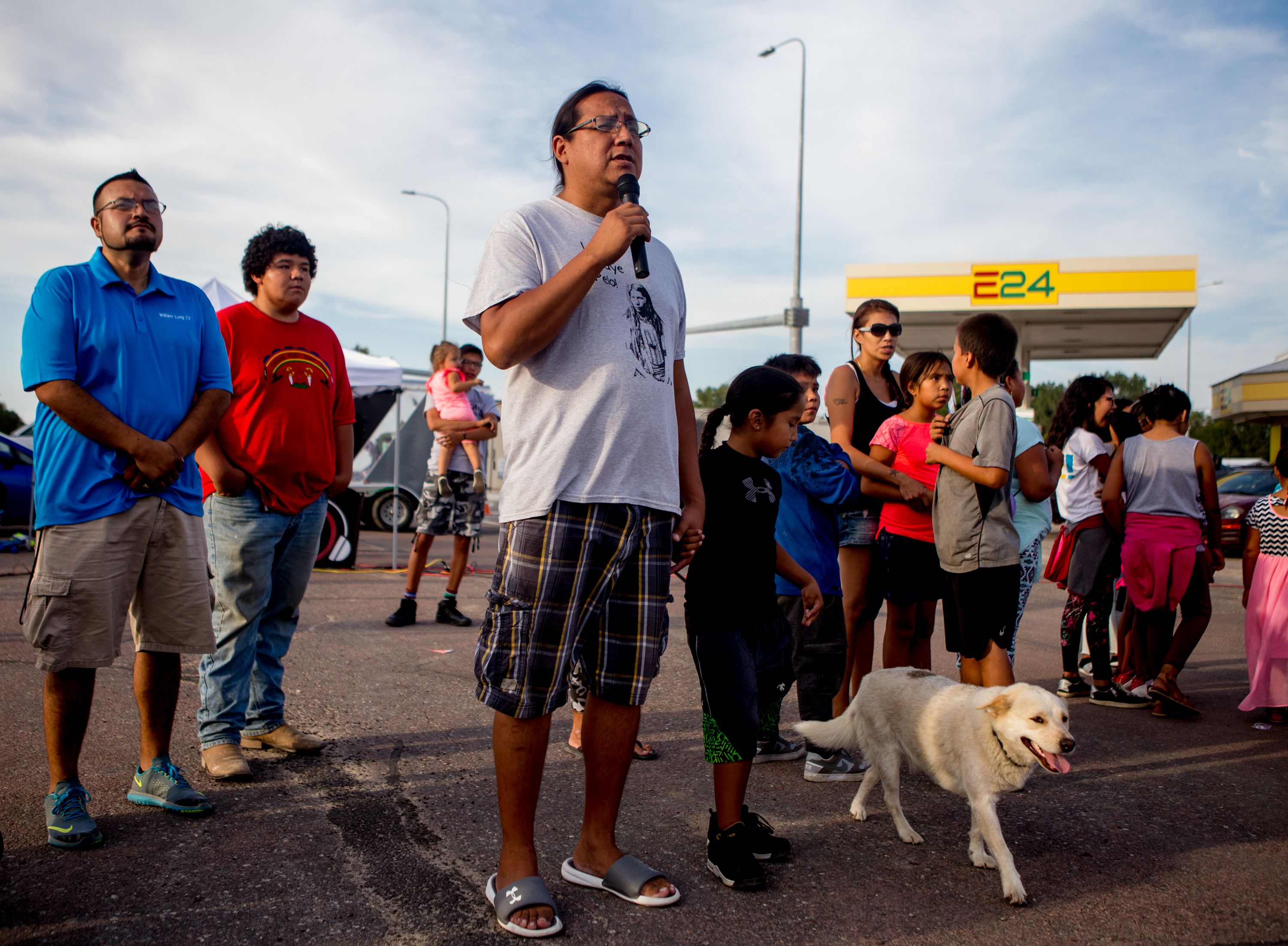 Sage Fast Dog, of the Rosebud Indian Reservation, speaks a prayer on September 1, 2018, during the first annual Sicangu Youth Program "Back-to-School" block party in Mission, South Dakota. Image by Brian Munoz. South Dakota, 2018.