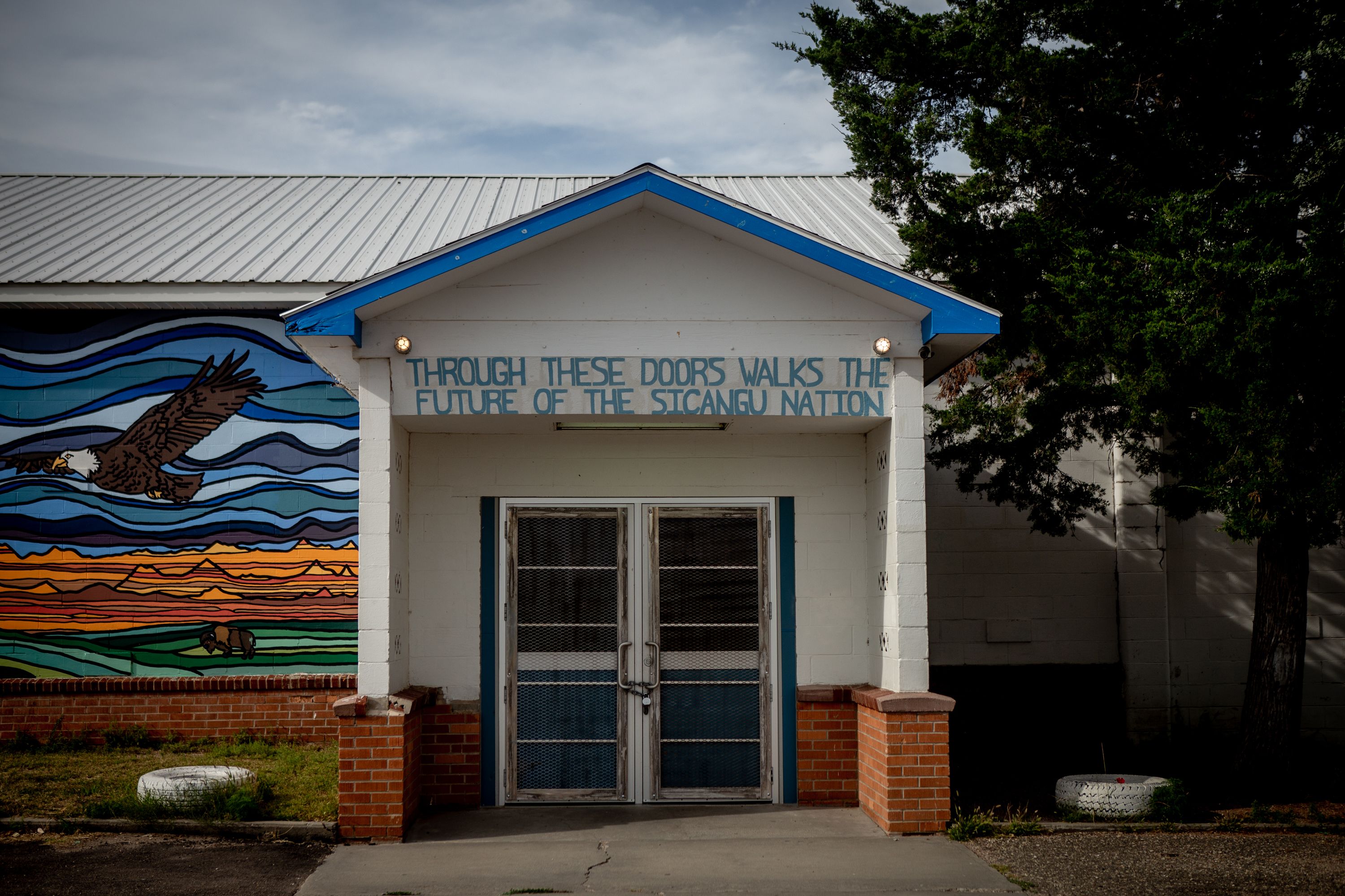 The entrance to the Boys and Girls Club is adorned with a new mural to the left on September 3, 2018, in Rosebud, South Dakota. Image by Brian Munoz. South Dakota, 2018.