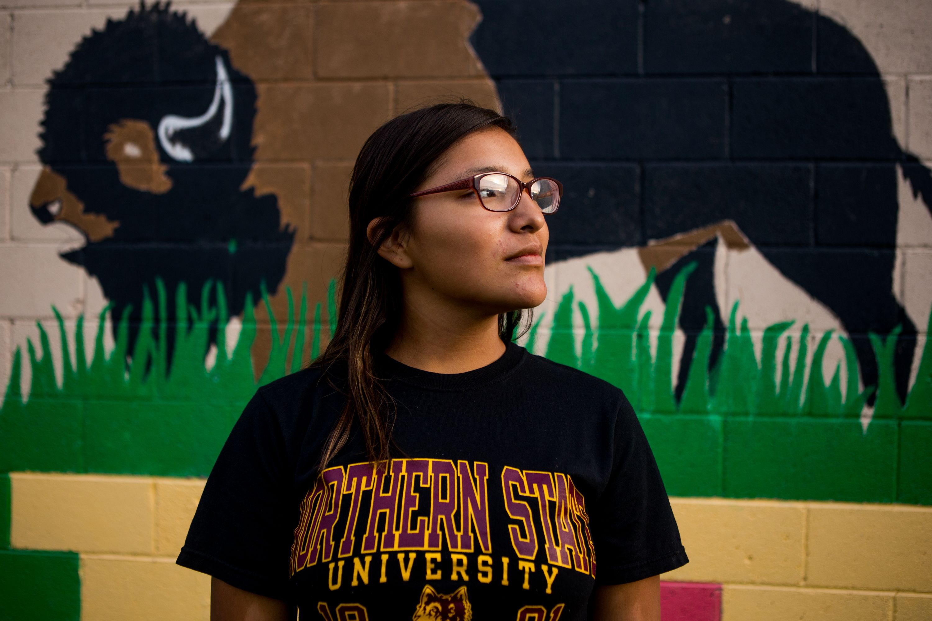 Tianni Arrow, 17, of Norris, South Dakota poses for a portrait on September 1, 2018, in downtown Mission, South Dakota. Arrow, a senior at Todd County High School, is one of 102 students to graduate from the high school this year—the first group to graduate a class of over 100 students in the history of the institution. Image by Brian Munoz. South Dakota, 2018.