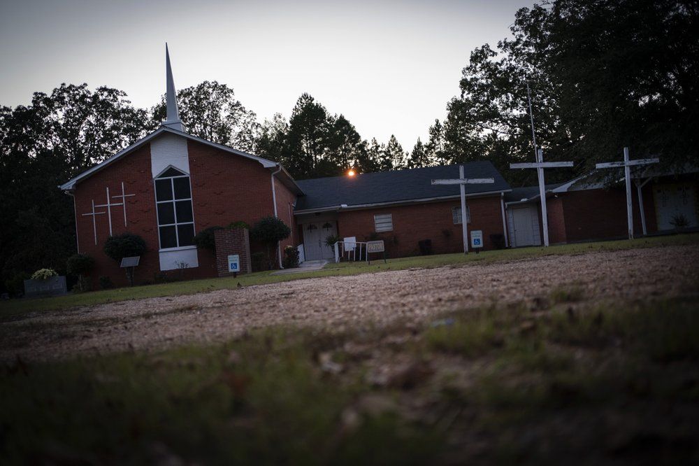 Mt. Zion United Methodist Church is pictured at dusk, in Philadelphia, Miss., on Sunday, Oct. 4, 2020. In the summer of 1964 the church had been burned down and its parishioners beaten by a group of Klansmen. After civil rights activists Michael Schwerner, James Chaney, and Andrew Goodman drove to the church to meet with witnesses to the KKK attack, the trio were later kidnapped and driven to a narrow country road where they were shot at close range. Their bodies were found in an earthen dam 44 days later. Image by Wong Maye-E / The Associated Press. United States, 2020.
