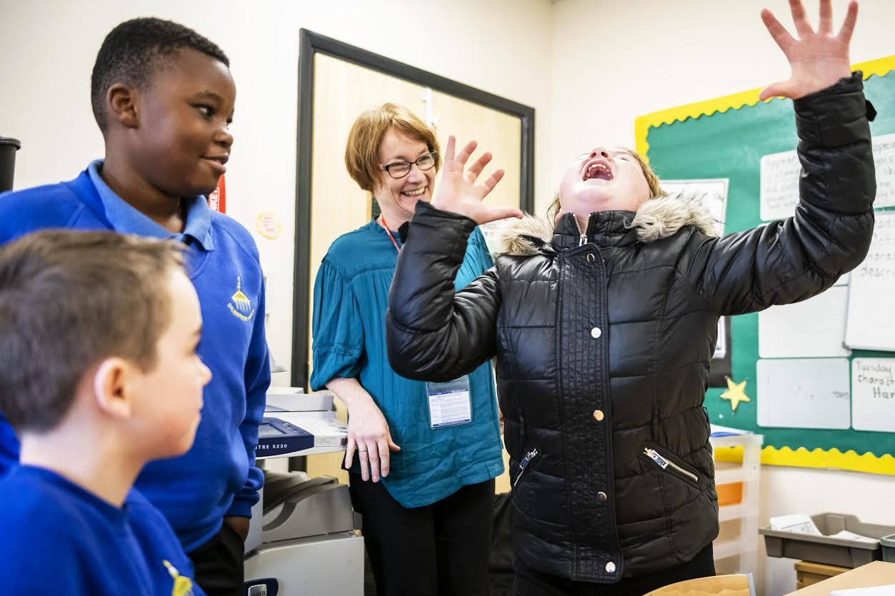 Kacper Misztal, 11, of Bridgeton, left, speaks about his life in Poland and wanting to return as Christian Phiri, 11, of Calton, center, and Sarah Ward listen to him speak, Wednesday, Oct. 23, 2019, at Delmarnock Primary School in Glasgow, Scotland. Image by Michael M. Santiago/Post-Gazette. United Kingdom, 2019.