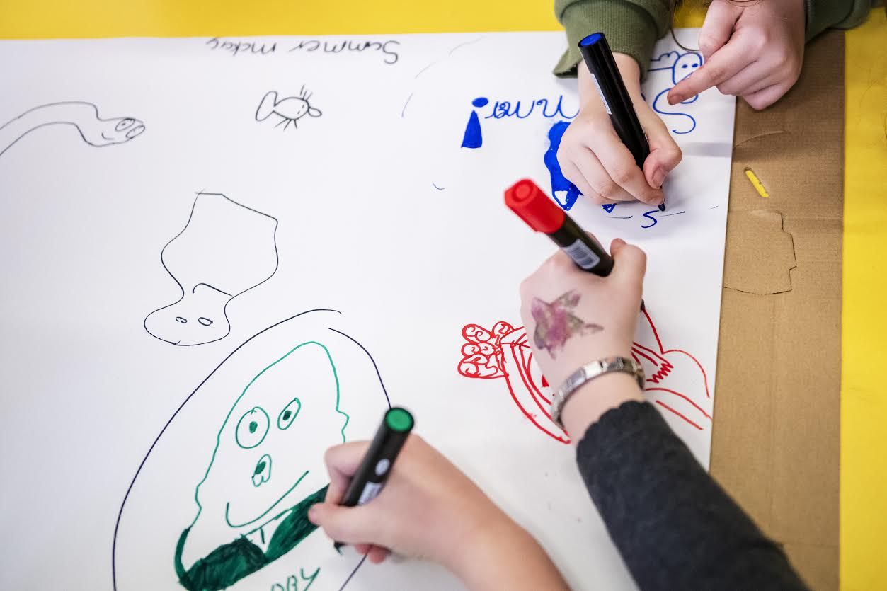 Children from the Children's Neighbourhoods Scotland program draw original characters while taking part in an art session, Wednesday Oct. 23, 2019, at Sacred Heart Primary School in Glasgow, Scotland. Image by Michael M. Santiago/Post-Gazette. United Kingdom, 2019.