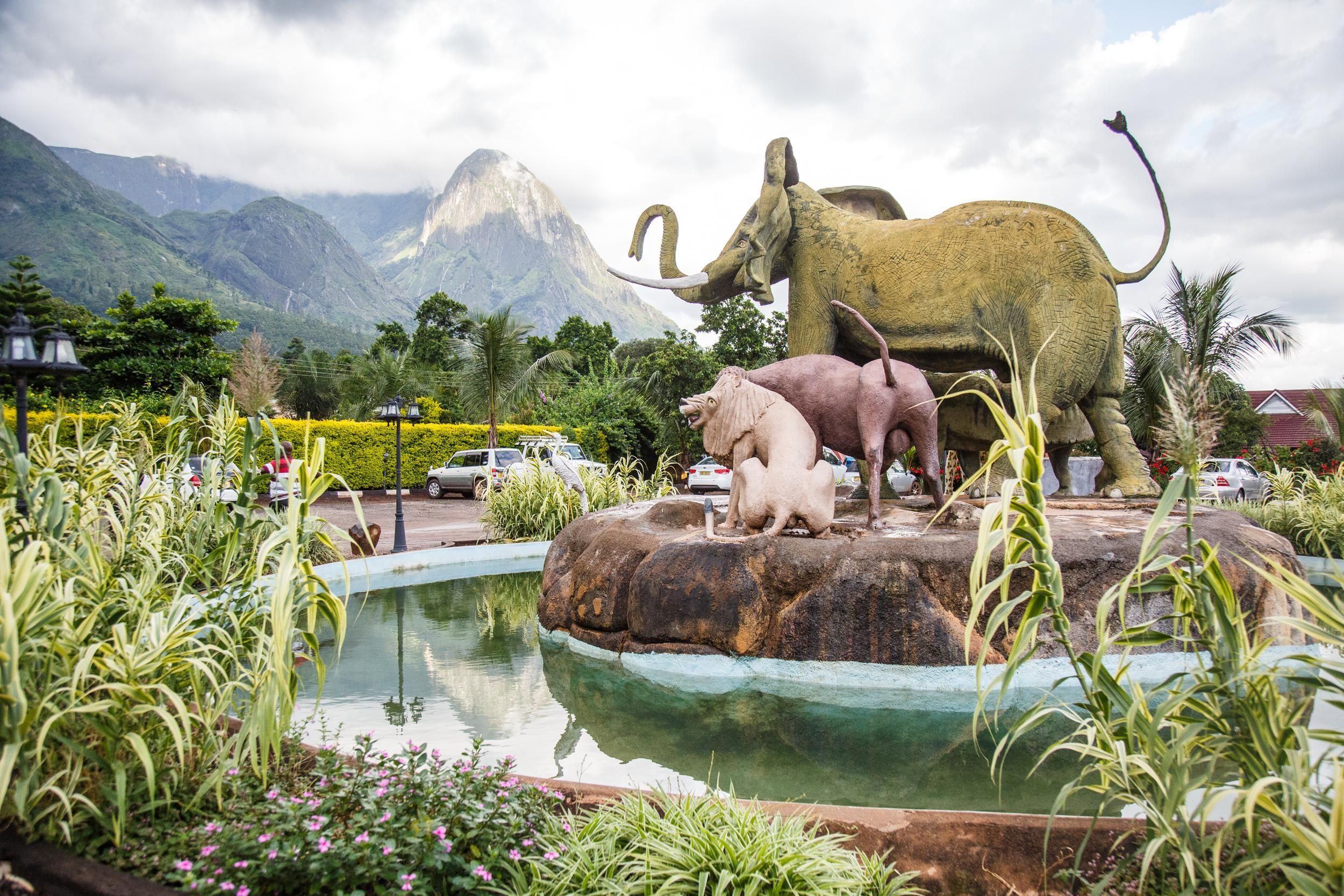A statue of Africa’s ‘Big Five’ towers in front of the ‘Hapuwani Village Lodge’, a luxurious resort in Mulanje, in the south of Malawi. Image by Nathalie Bertrams. Malawi, 2017.