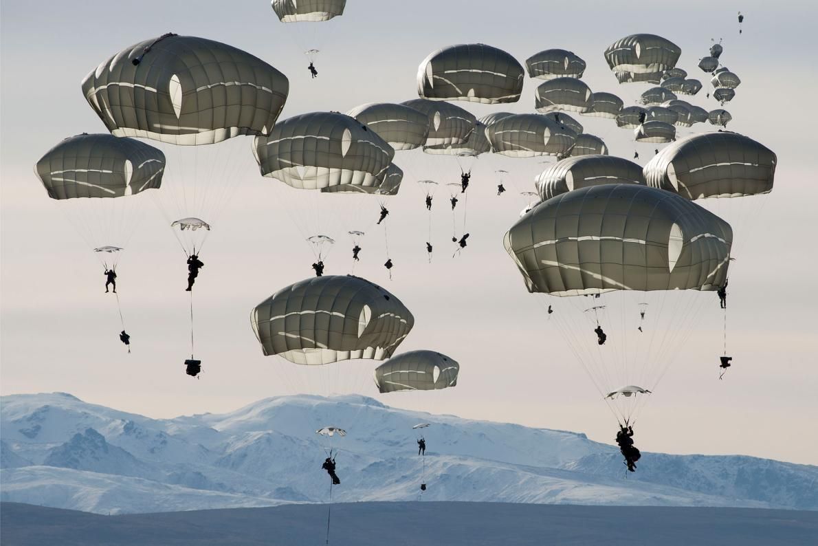 U.S. soldiers drop over the Donnelly Training Area near Fort Greely, Alaska. In October 2018, the training area hosted some 6,000 soldiers during a war games exercise named Arctic Anvil. Image by Louie Palu. United States, 2018.