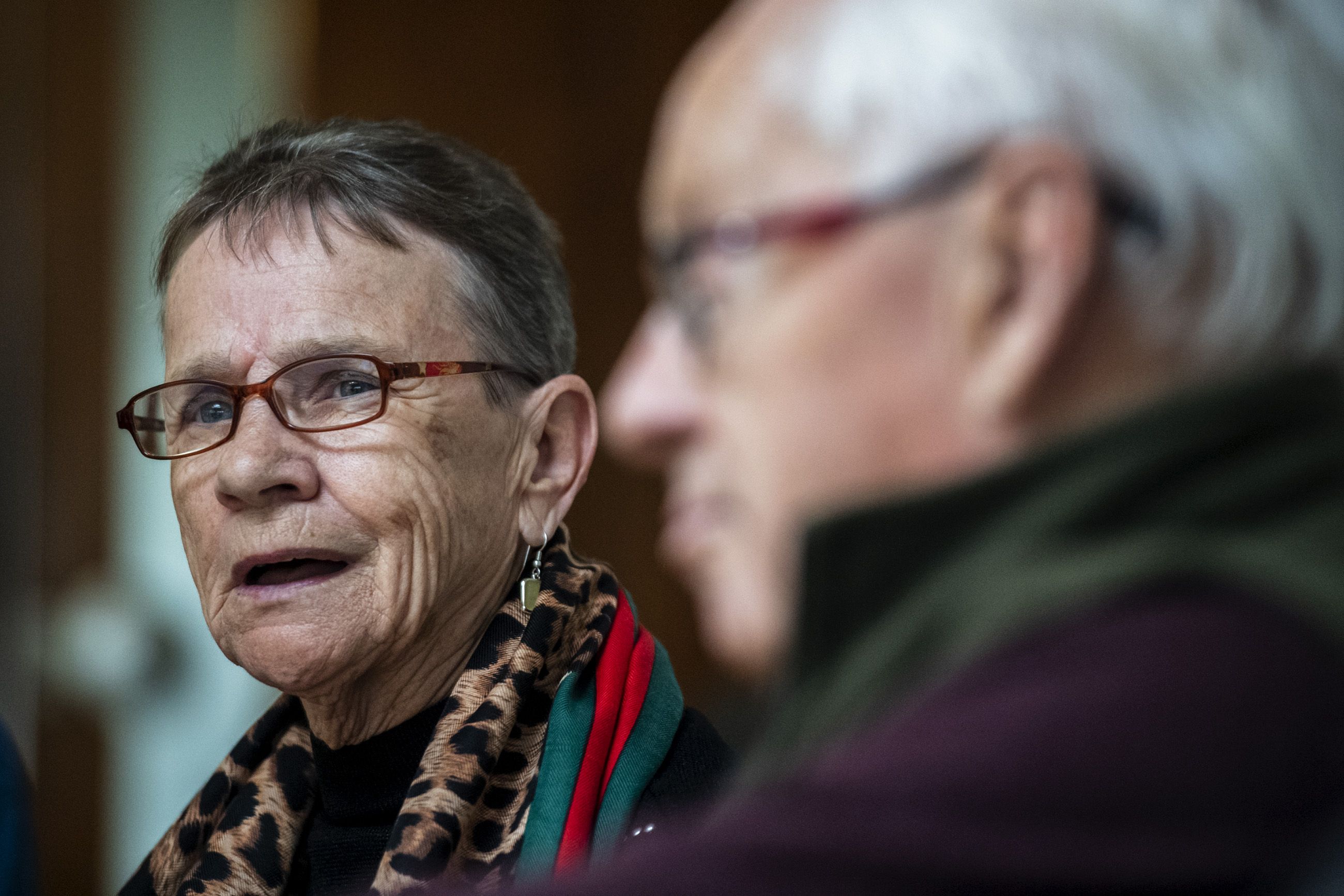 Jean Forrester, of Possilpark a neighborhood of Glasgow, speaks during the monthly Poverty Truth Community meeting as John Harvey, of Govan, a neighborhood in Glasgow, listens. Image by Michael Santiago. United Kingdom, 2019.