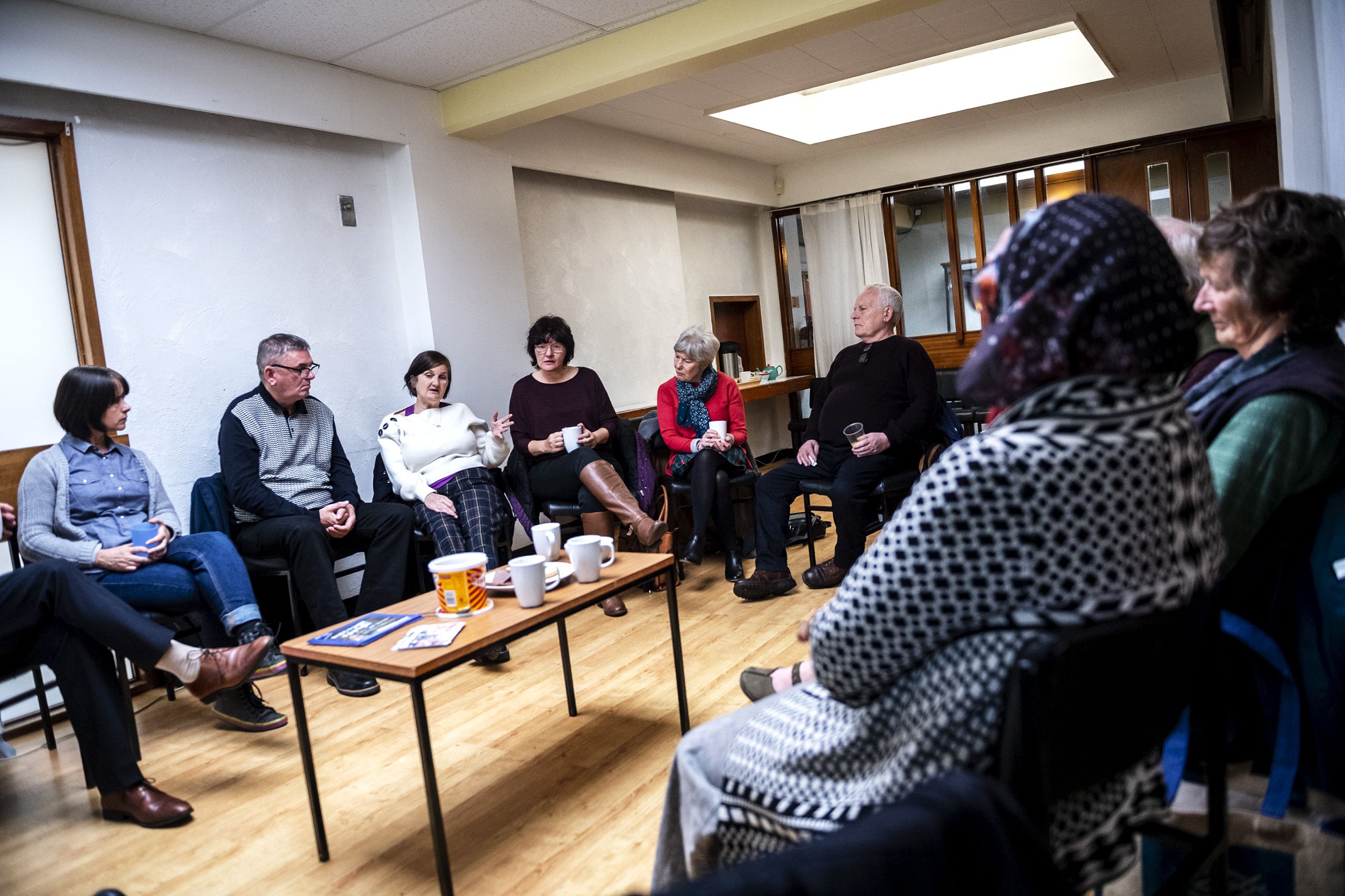 People meet for the monthly Poverty Truth Community meeting at The Pyramid at Anderston in Glasgow, Scotland. The Poverty Truth Community is an organization that helps people overcome poverty in Scotland. Image by Michael Santiago. United Kingdom, 2019.
