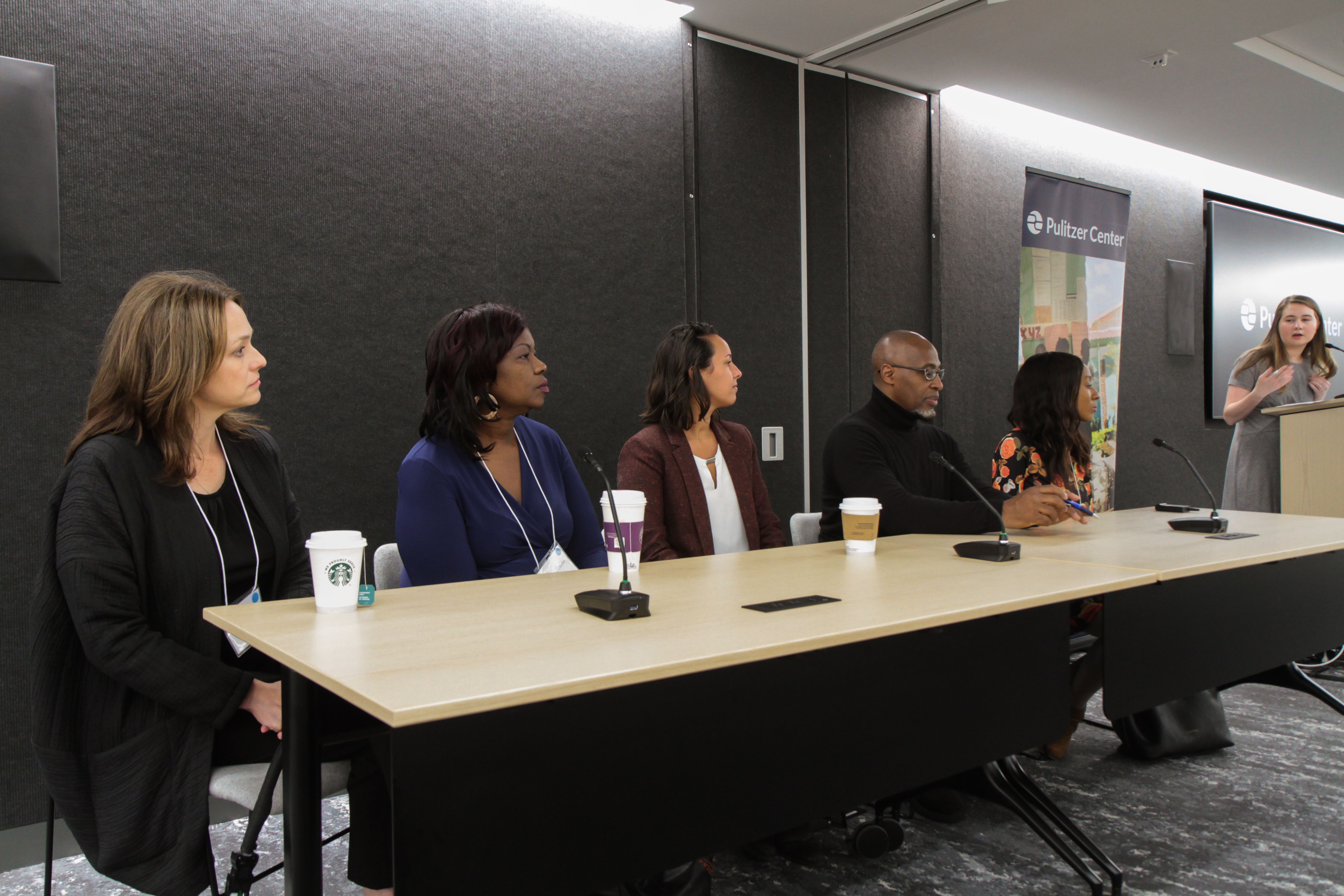 Pulitzer Center outreach coordinator Holly Piepenburg introduces the five panelists. From left to right: Time for Kids executive editor Jaime Joyce; Miami Herald correspondent Jacqueline Charles; digital video producer for National Geographic Gabrielle Ewing; senior investigative reporter for WGBH Phillip Martin; and multimedia reporter Melissa Noel. Image by Libby Moeller. United States, 2019.