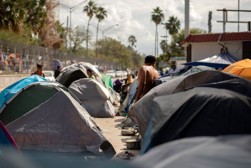 Rows of tents are clustered near the Gateway International Bridge in Matamoros, Mexico. Image by Miguel Gutierrez Jr. Mexico, 2019.