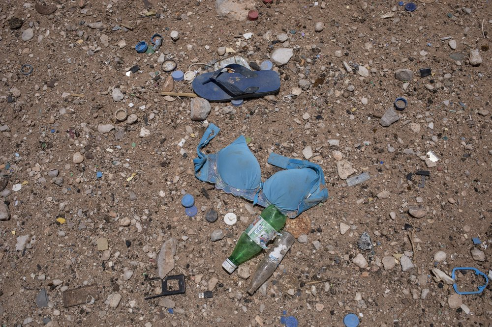 A bra on the ground where African migrants are held in desert compounds, known in Arabic as "hosh" in Shabwa, Yemen. Many migrants are subjected to daily torments ranging from beatings and rapes to starvation. Image by Nariman El-Mofty. Yemen, 2019.