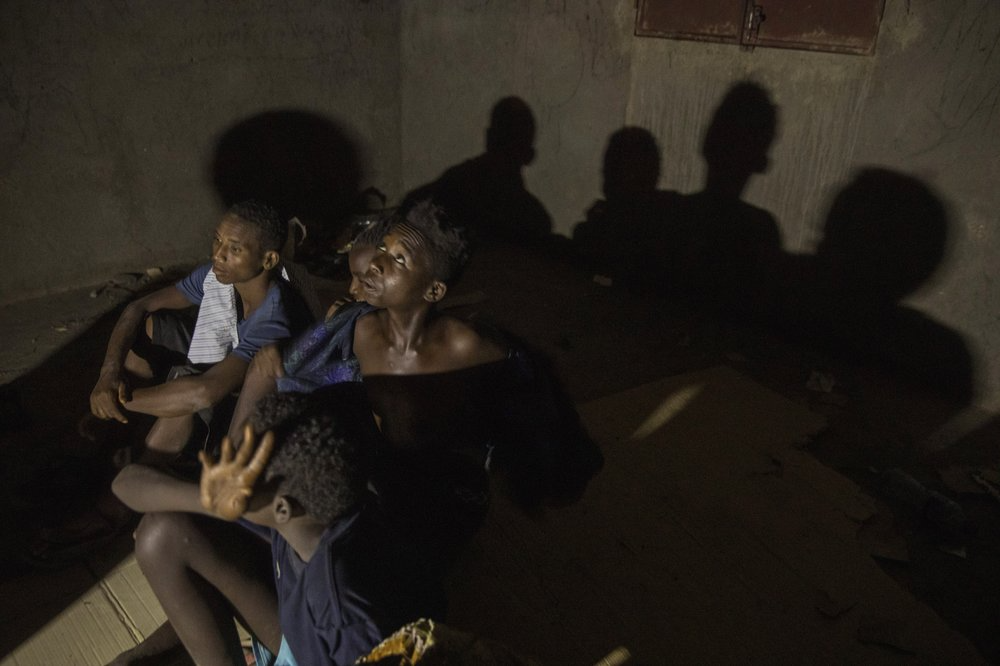 Ethiopian migrant boys ages 13 to 16, who crossed at night from Ethiopian borders, rest in an abandoned one-floor, brick house in Ali Sabeih, Djibouti. Migrants take shelter here until early morning to continue their journey. Image by Nariman El-Mofty. Djibouti, 2019.