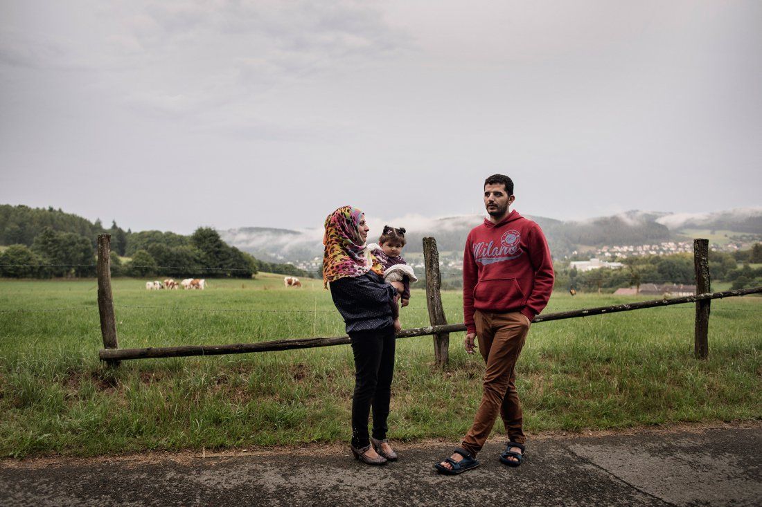 Nour Altallaa, her husband Yousef Alarsan and their daughter Rahaf explore their new home in a camp near Bad Berleburg, Germany, on July 19. Image by Lynsey Addario. Germany, 2017.