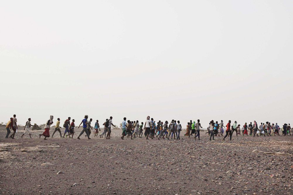 Smugglers lead Ethiopian migrants in Obock, Djibouti. Image by AP Photo/Nariman El-Mofty. Djibouti, 2020.