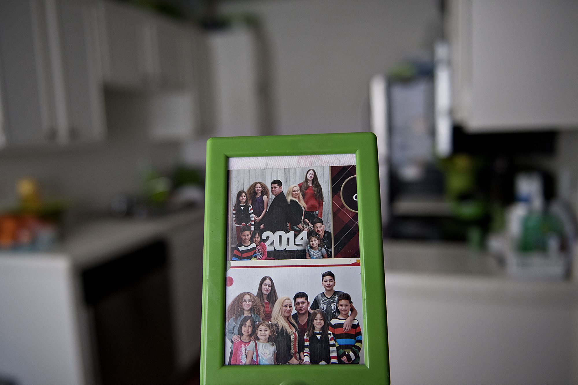 Photos of the Flores family from the past are seen in their Chula Vista kitchen. Image by Amanda Cowan. United States, 2019.