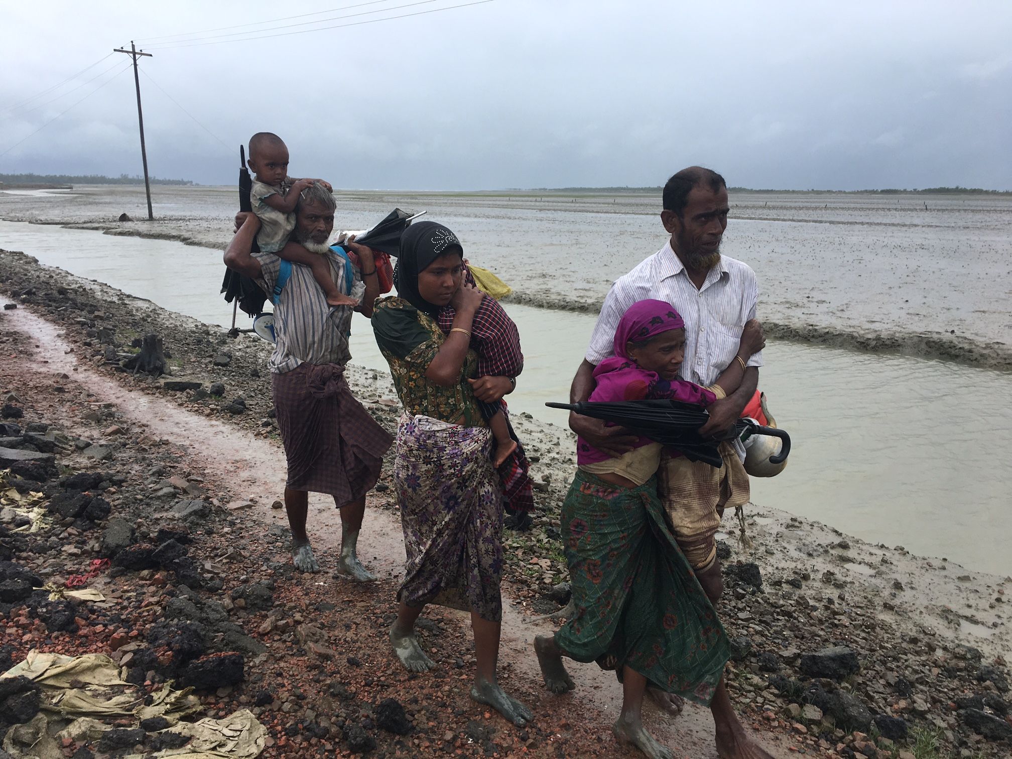 A Rohingya Muslim family displaced by violence in Myanmar heads toward refugee camps near the Bangladesh coast. September 2017. Image by Jason Motlagh.