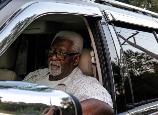Pepper Holder sit in his SUV in front of one of the entrances to the old Koppers Tie Plant in Carbondale, Illinois on August 24, 2020. Image by Amelia Blakely. United States, 2020.