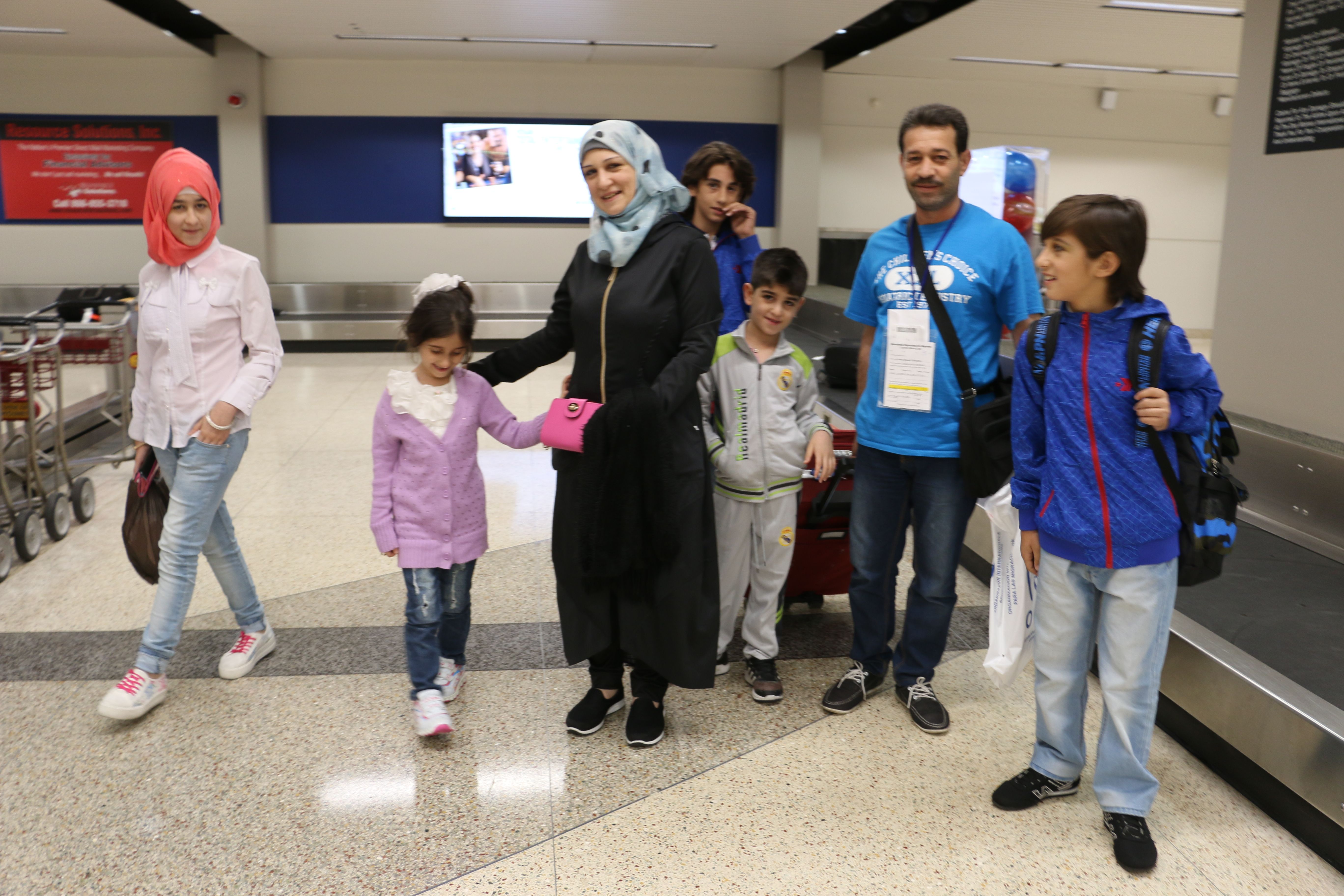 Ghazweh Aljabooli and her husband and five children arrive in the Des Moines airport just before midnight one night in June 2016.