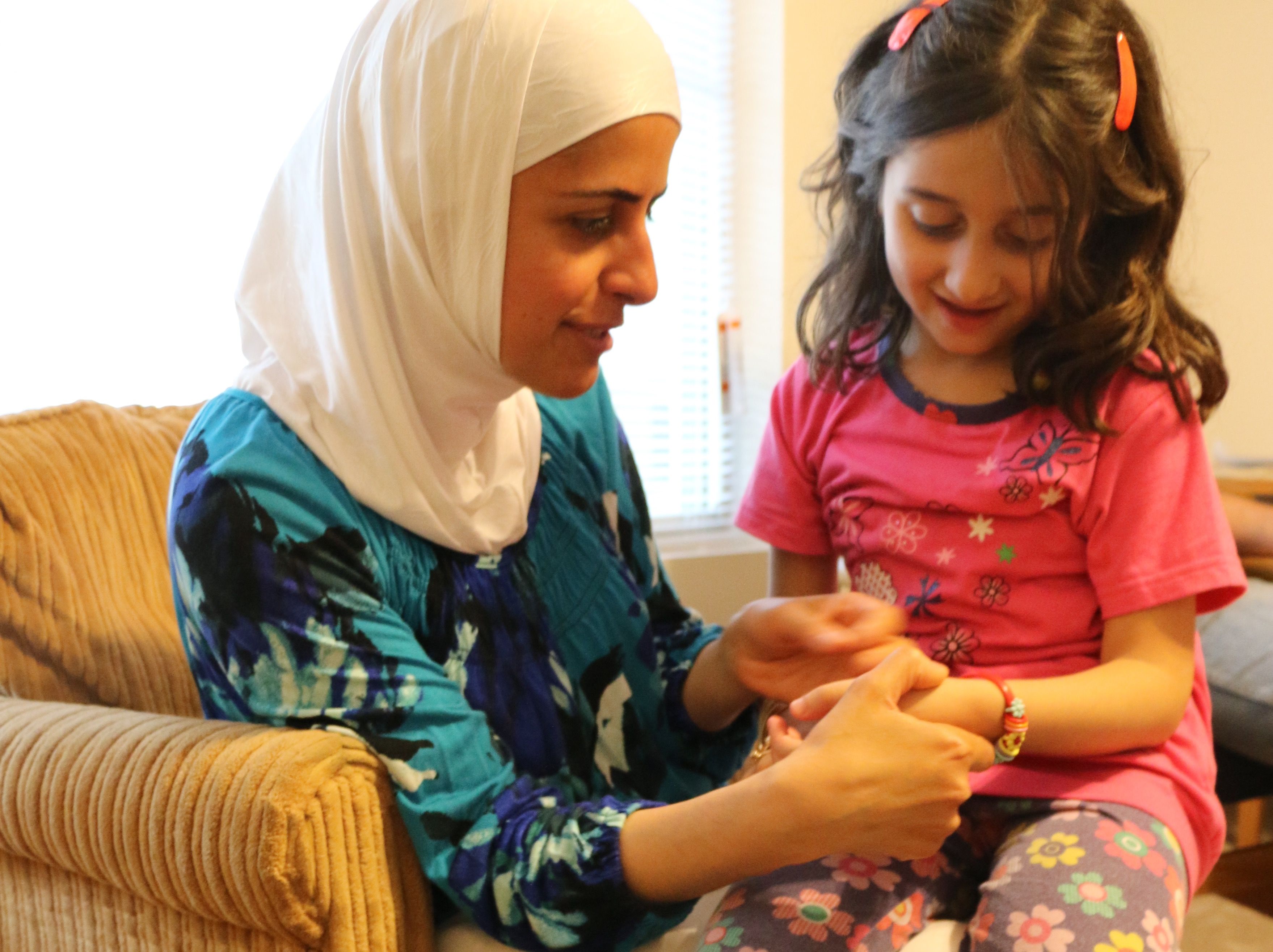 The settlement agency in charge of Ghazweh's family identified four Syrian families previously living around Des Moines. Ghinwa Alameen, a Syrian professor of linguistics, picks up Ghazweh's daughter Hala when she visits to welcome the newcomers.