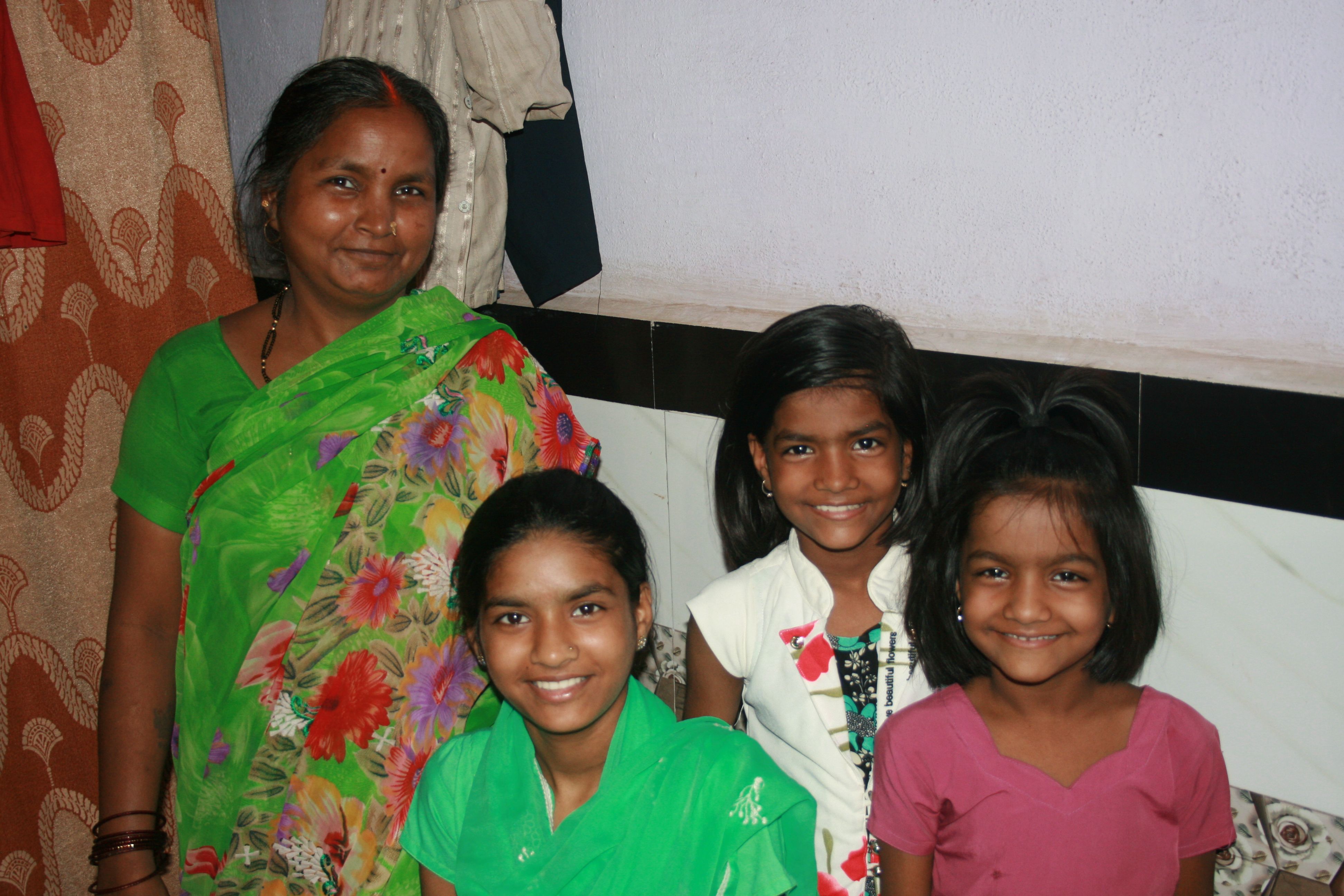 Rima Prajapati with daughters (from left) Jhoti, Aarti and Sangeeta. Jhoti and Aarti were both born deaf. Rima moved her daughters from their village to Mumbai so they could attend a school for the deaf. Image by Kate Petcosky-Kulkarni. India, 2016.