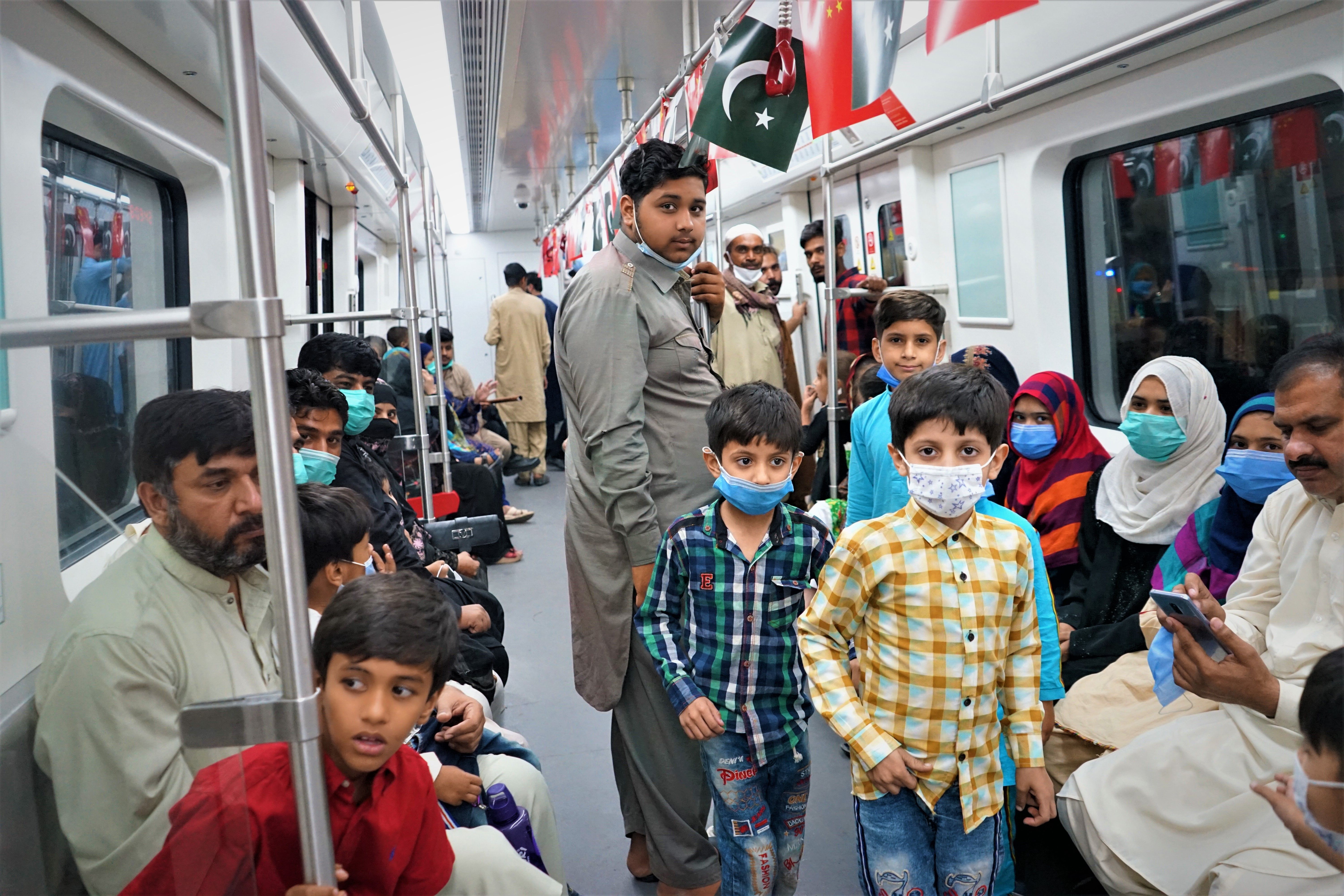 Lahoris riding the Orange Line for the first time. The railway will improve the lives of many in the city. Image by Sabrina Toppa. Pakistan, 2020.