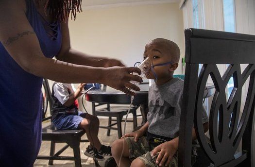Four-year-old Jeremiah Galbreath receives a nebulizer treatment for asthma at his home in Bayboro. Image by Travis Long / The News & Observer. United States, 2020.