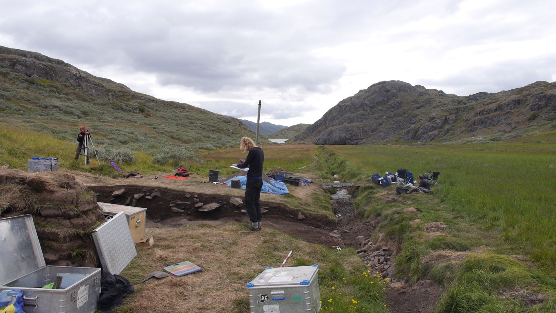 Archeologist Elie Pinta takes height measurements at an archeological dig in southern Greenland. The excavation, at a place, known today at Tasilikulooq, focuses on a site that once housed a small Norse dairy farm. Image by Eli Kintisch. Greenland, 2016.