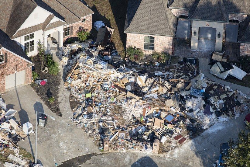 Hurricane Harvey is expected to be the costliest natural disaster in U.S. history. Thousands of homes were flooded, many requiring major repairs. Here debris piles await removal from gutting two homes in Northwest Forest, a subdivisions of Beaumont. Image by Dan Grossman. United States, 2017. 