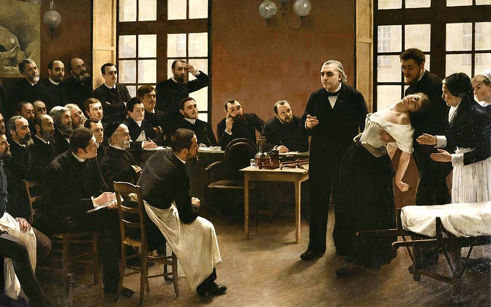 A Clinical Lesson at the Salpêtrière by Pierre Aristide André Brouillet (1857-1914) featuring Dr Charcot. Image courtesy Wiki Commons. 