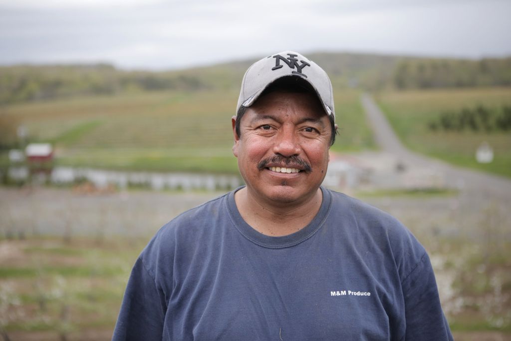 Winny Contreras poses for a portrait in front of the farmland he's spent 24 years cultivating in Connecticut. Image by Ingrid Holmquist. United States, 2018.