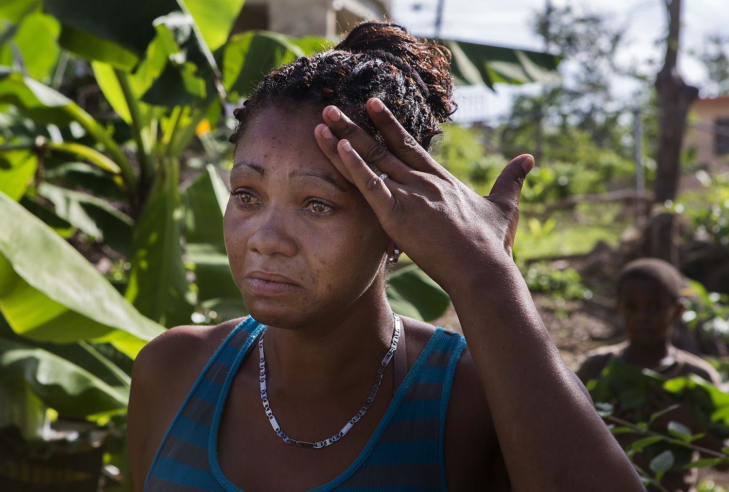 Rosalda Olma, a wife and mother to three kids, begins to tear up while sorting through what remains of her home in Loiza. The entire home and contents were destroyed by the hurricane, and the family is living in a nearby school for the time being. “It’s hard getting used to these living conditions,” she said. “All five of us are trying to fit inside a single room.” Image by Ryan Michalesko. Puerto Rico, 2017. 