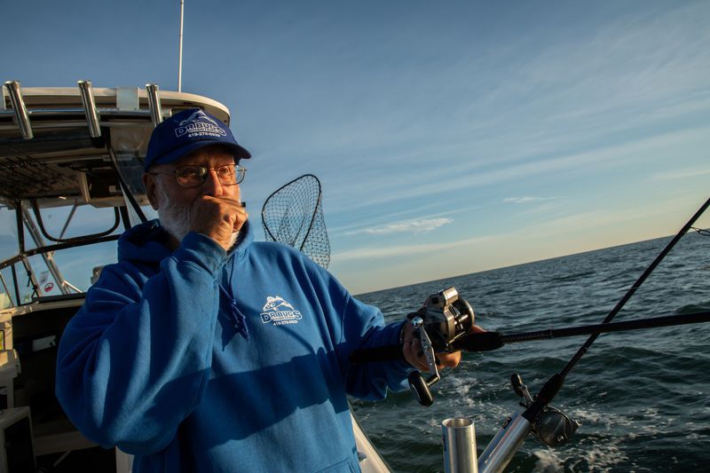 Captain Dave Spangler, 72, owner of boat Dr. Bugs in Oak Harbor, Ohio, fishes for walleye in Lake Erie on Sept. 25, 2019. He works on environmental issues with Lake Erie Charter Boat Association. Image by Zbigniew Bzdak. United States, 2019.
