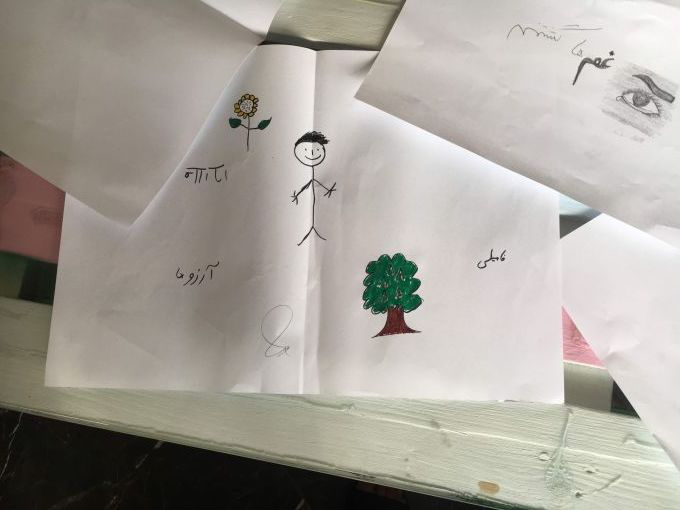 During an art therapy session, unaccompanied minors were asked to draw or write things that get them through each day. A 17-year-old Afghan drew a tree with what he identified as grapes, along with the words hope and family. The grapes on the tree symbolized alcohol, he said. Early initiation of substance abuse is linked to adverse childhood experiences, which are ubiquitous among unaccompanied minors. Image by Divya Mishra. Greece, 2018. 