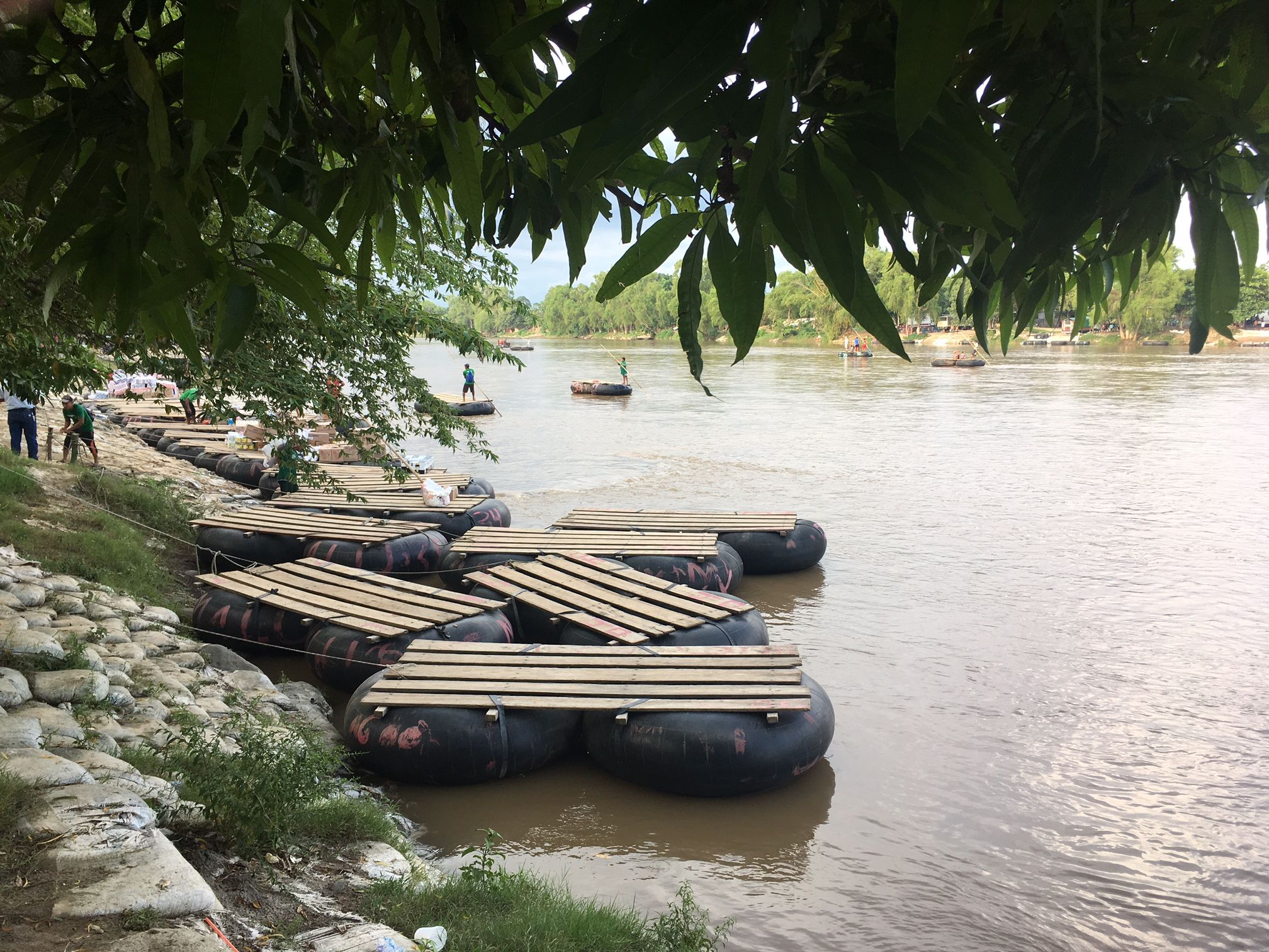 Rafts on the bank of the Suchiate River, which runs between Guatemala and Mexico. These rafts—largely ferrying market-goers and vendors—are also frequently used by U.S.-bound migrants crossing into Mexico. Image by Lauren Markham. Guatemala, 2018.