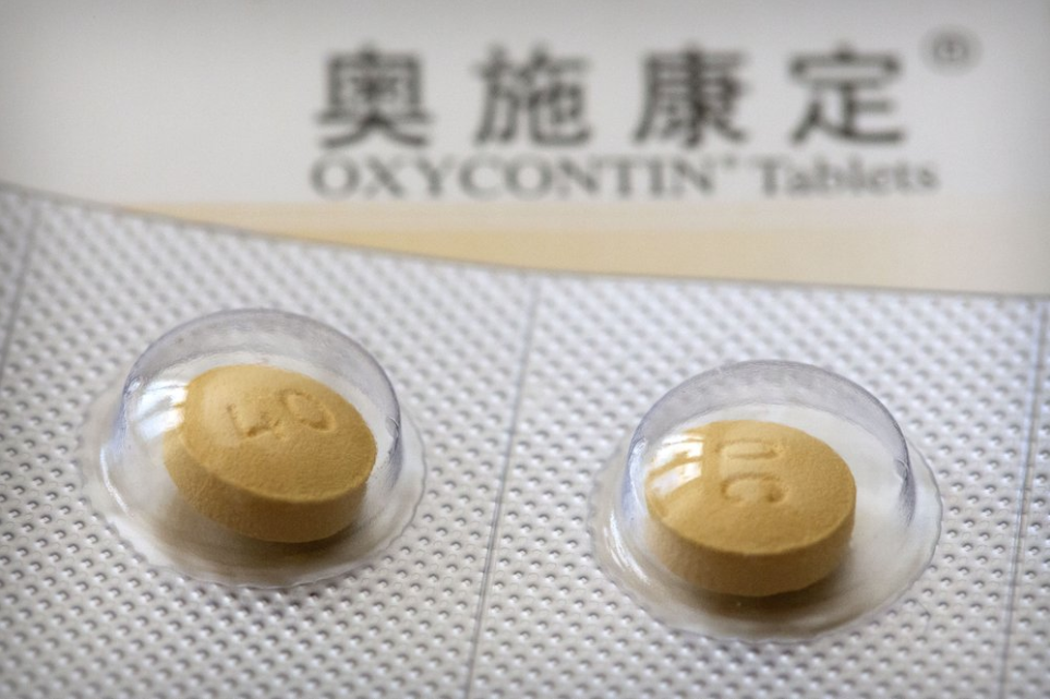 This Sept. 24, 2019 photo shows 40-milligram OxyContin tablets sold in China in Hunan province. OxyContin's U.S. FDA-approved label warns that even if taken as prescribed, the opioid carries potentially lethal risks of addiction and abuse. Image by Mark Schiefelbein / AP Photo. China, 2019.