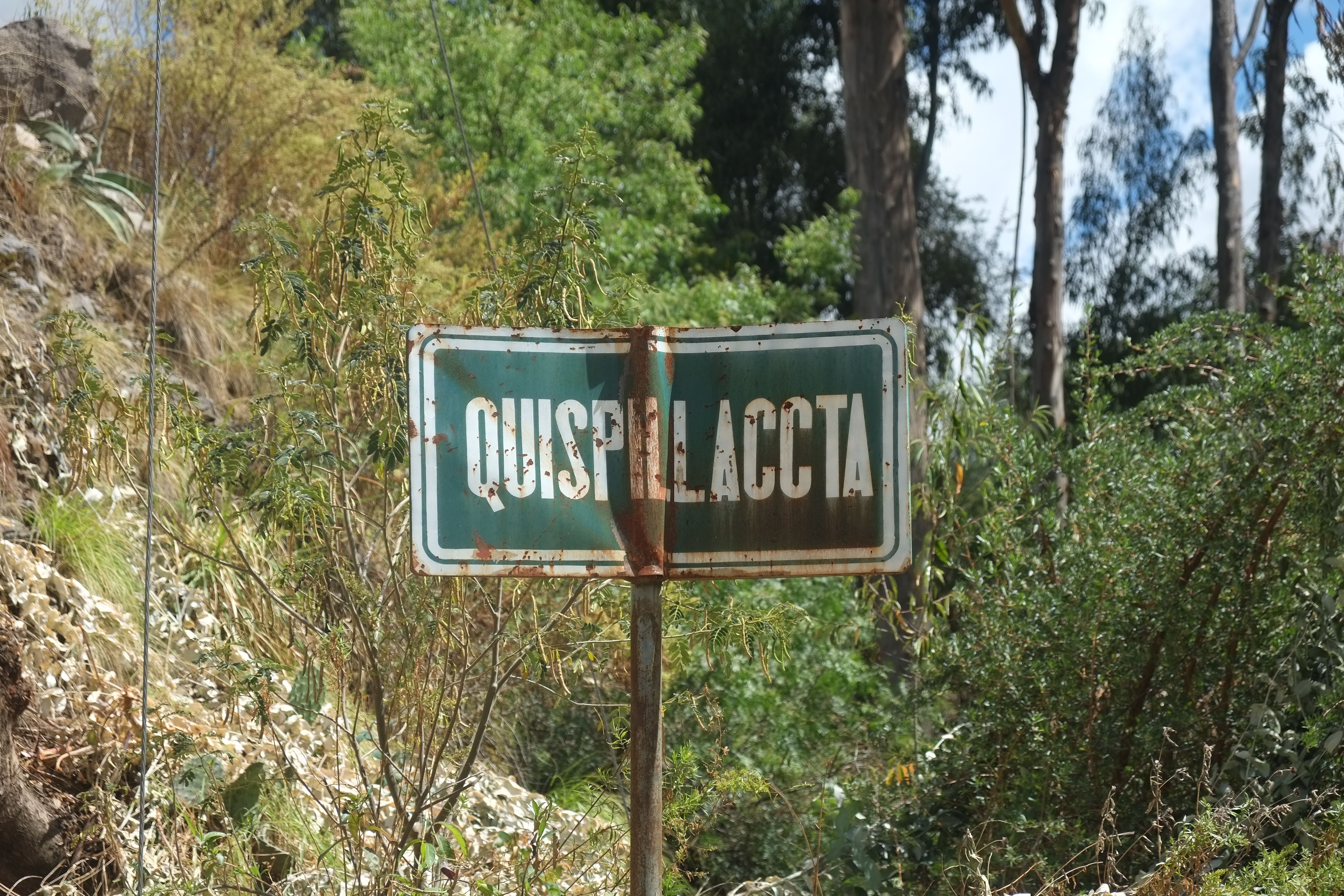 An old sign marking a road into Quispillaccta, Peru. Image by Dan Schwartz. Peru, 2019.