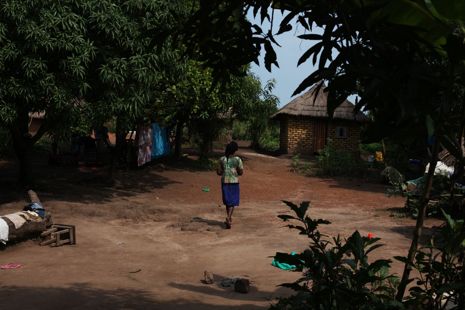 A 17-year-old mother, released by militia forces, walks around the compound where she lives with her two sisters. Like her, and like her grandmother, they were kidnapped and held by rebel soldiers. The girl was pregnant when she was released. Image by Andreea Campeanu. South Sudan, 2018.