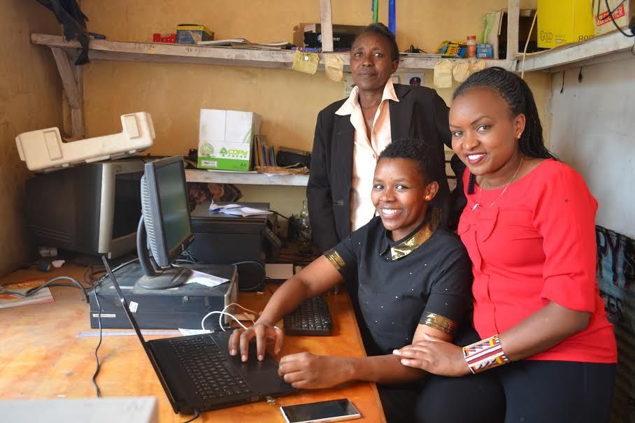 Magdaline Sointa helping run her family's cybercafe with her mom, Louisa, and sister Sylvia.  Image by Janelle Richards. Kenya, 2017.