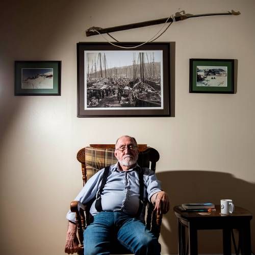 Alex Saunders, 78, sits at his home in the military base town of Happy Valley-Goose Bay, Labrador. He says he’s had to adapt to a changing world, and that Canadian hydro-electricity projects supported by New England’s energy purchases are threatening the traditional way of life of the region’s Innu and Inuit. Image by Michael G.Seamans. Canada, 2019.