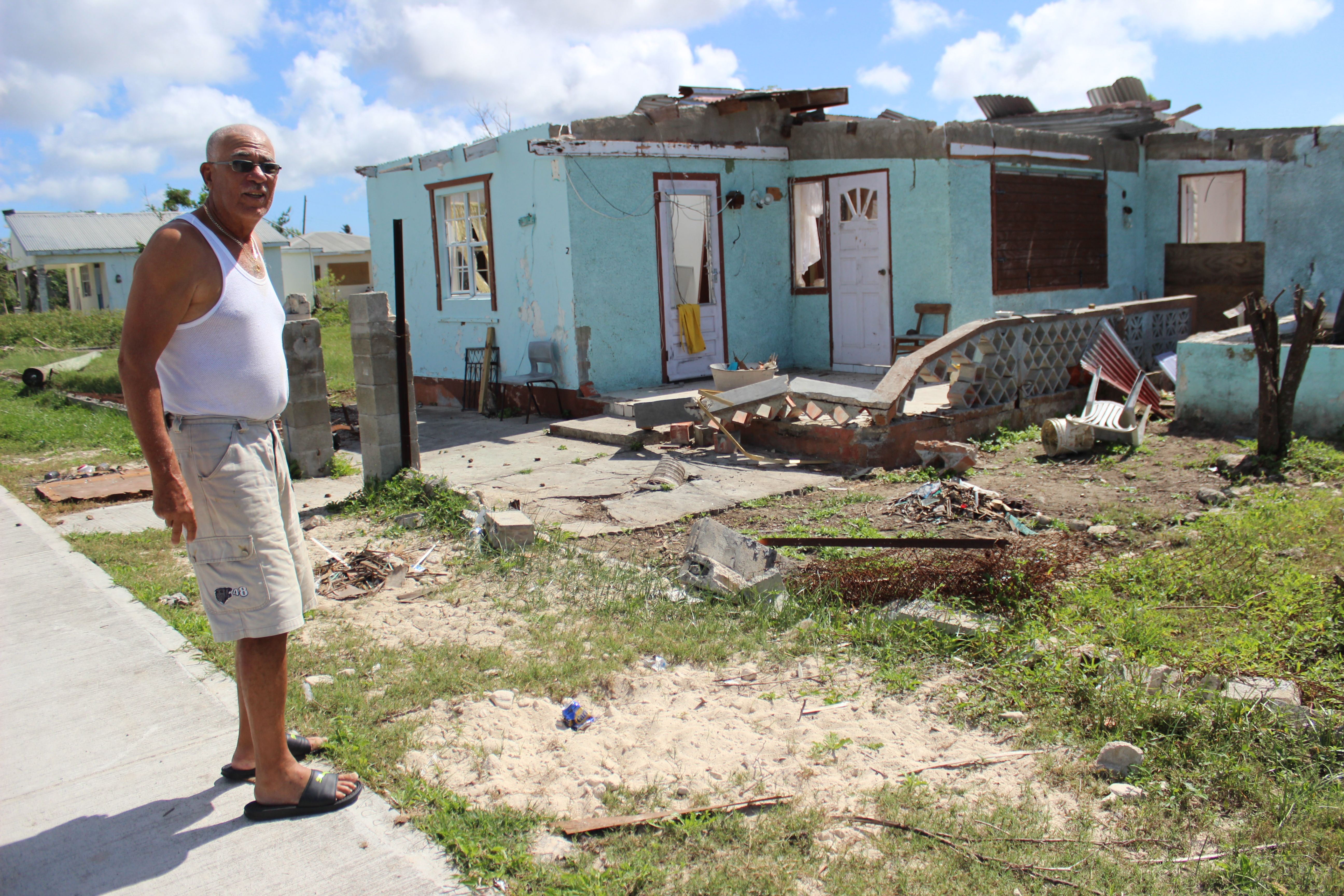 Cliff Drinkwater, a 73-year-old pensioner, surveys the damage to his childhood home in Barbuda's capital Codrington November 17, 2017. An estimated 90 percent of properties were damaged in Barbuda when the Caribbean island was hit by Hurricane Irma on Sept, 6, 2017. Image by Gregory Scruggs. Barbuda, 2017.