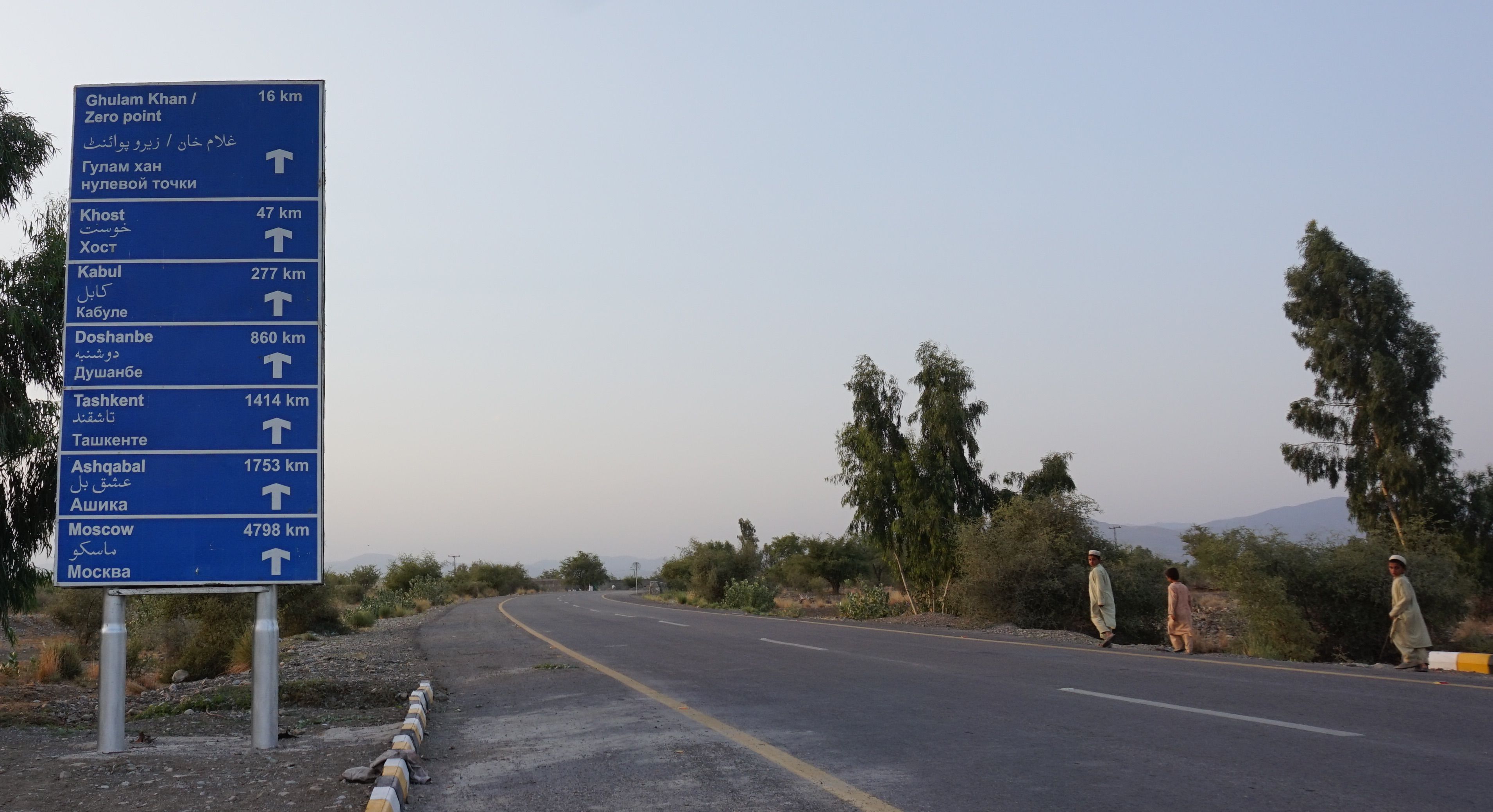 A sign indicating distances in Miran Shah, on the road leading to Afghanistan. Image by Umar Farooq. Pakistan, 2017. 
