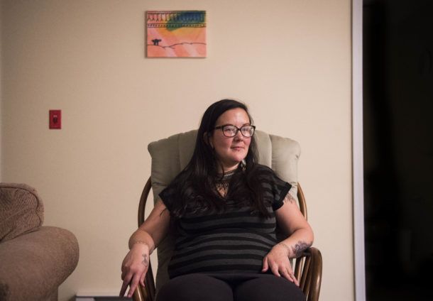 Erin Saunders, 35, at her apartment in the military base town of Happy Valley-Goose Bay, Labrador. Saunders was arrested protesting the construction of a local Canadian hydropower dam, which she says threatens her way of life. Image by Michael G. Seamans. Canada, 2019.