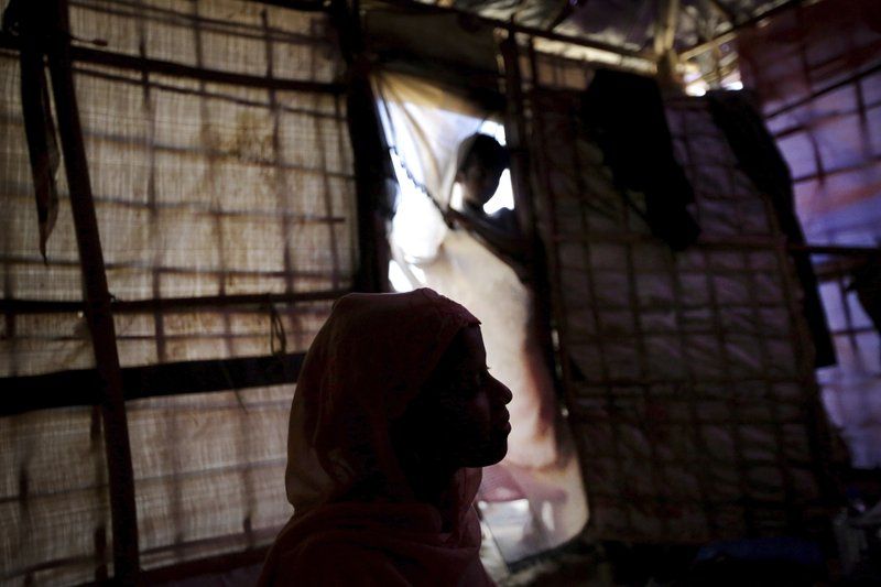 In this Sunday, Nov. 19, 2017, photo, R, 13, is seen in silhouette as she speaks to The Associated Press in her tent in Kutupalong refugee camp in Bangladesh. The Associated Press has found that the rape of Rohingya women by Myanmar’s security forces has been sweeping and methodical. The AP interviewed 29 women and girls who say they were raped by Myanmar’s armed forces, and found distinct patterns in their accounts, their assailants’ uniforms and the details of the rapes themselves. The most common attack involved groups of soldiers storming into a house, beating any children inside and then beating and gang raping the women. Image by Wong Maye-E. Bangladesh, 2017.
