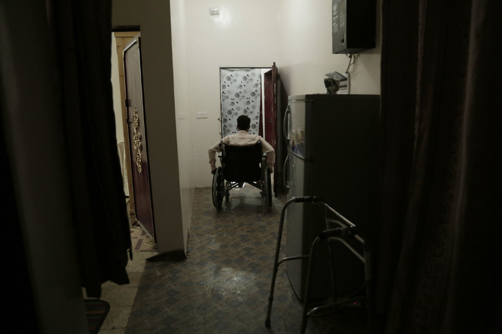 Anas al-Sarrari pushes his wheelchair in his home in Marib, Yemen Image by Nariman El-Mofty for AP News. Yemen, 2018.