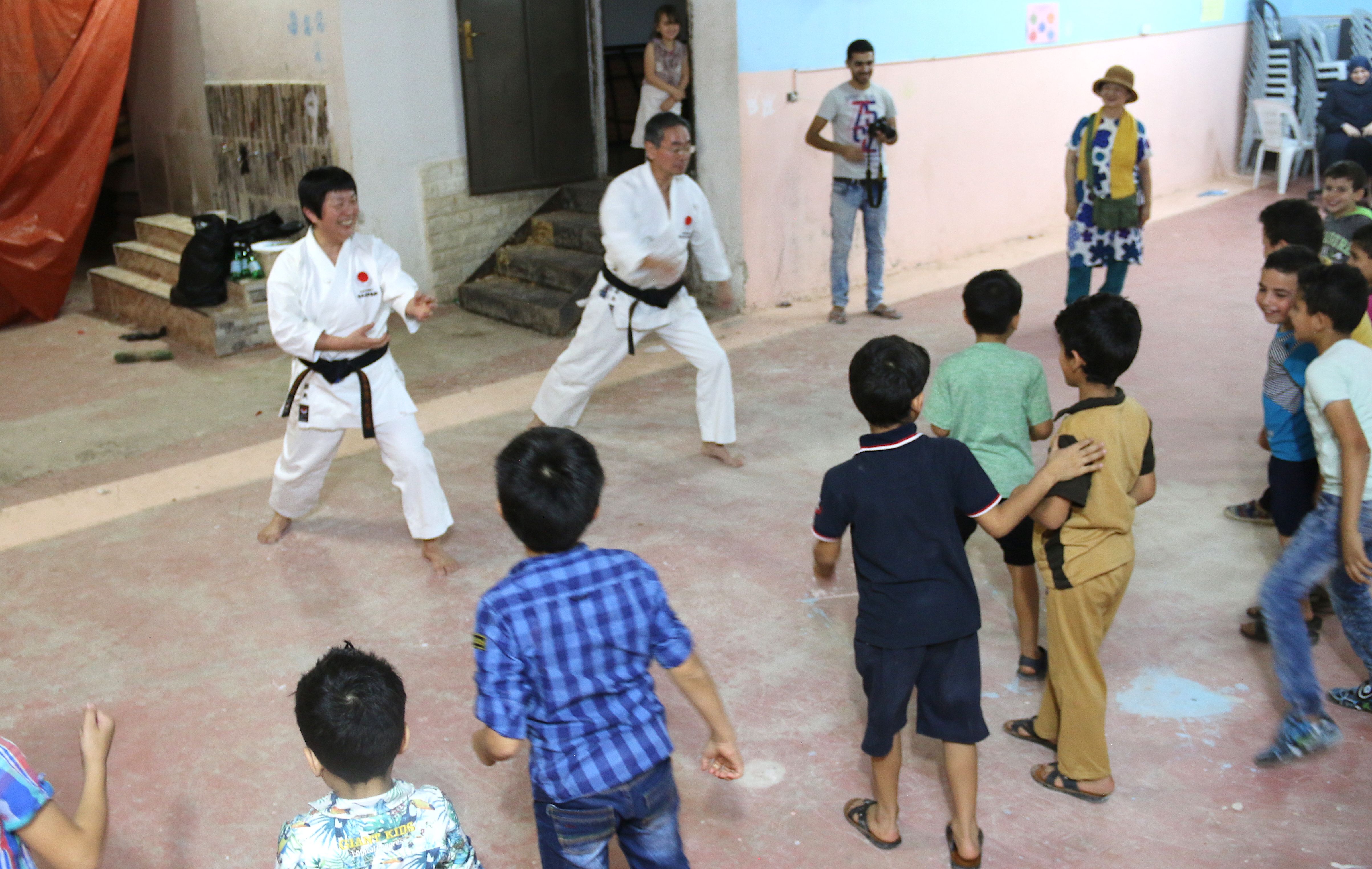 Children relieve stress at Homs League Abroad with various activities. Here they are practicing karate moves with a Japanese volunteer team. Image by Sawsan Morrar. Jordan, 2017.