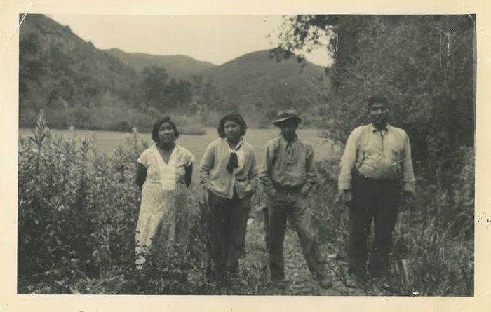 An archival photo from the early to mid-1930s of Allison Herrera's family near Toro Creek, an ancestral village of their Salinan Tribe. From left: Felista Rosas, her great-grandmother; Anna Herrera, her grandmother; Andy Rosas, Anna's brother; and Ramon Rosas, Andy and Anna's uncle. Image courtesy Allison Herrera.